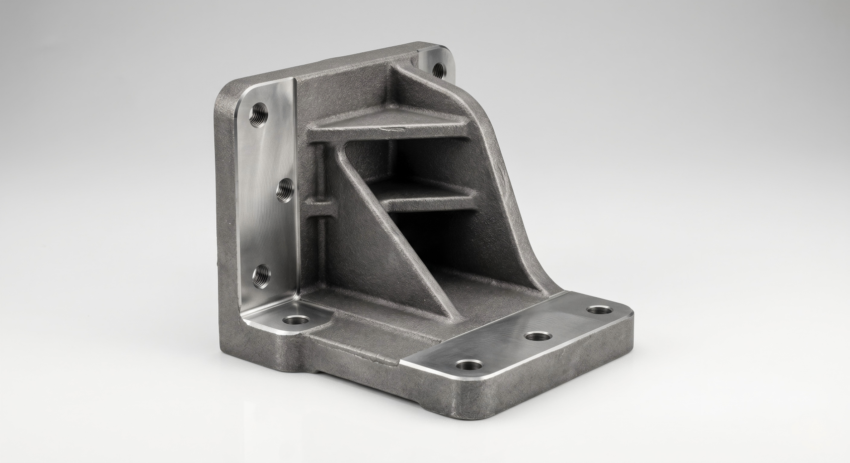Investment cast structural bracket for industrial machinery assembly