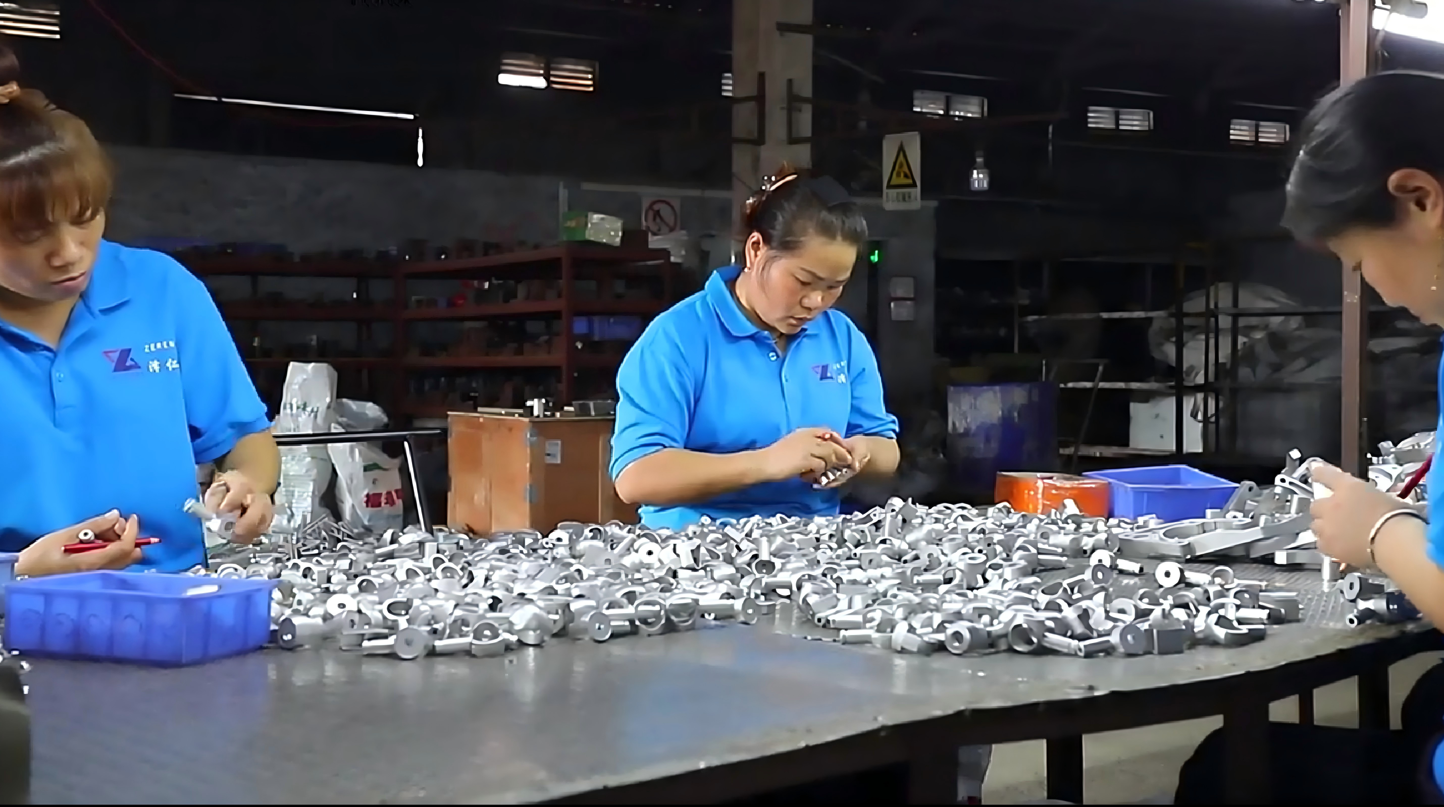 Zeren workers inspecting and sorting a production batch of precision steel components