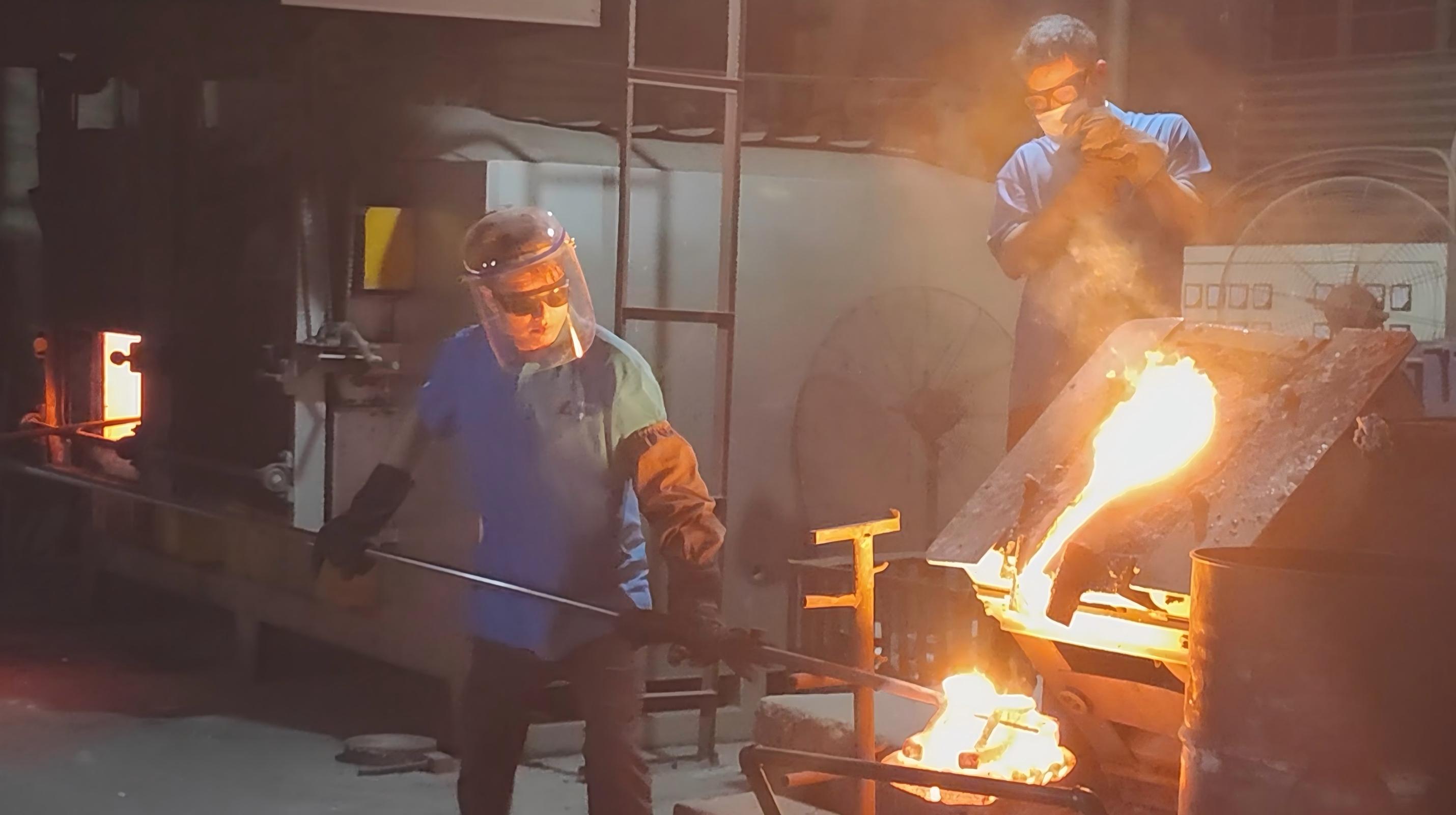Workers pouring molten steel during investment casting production at Zeren